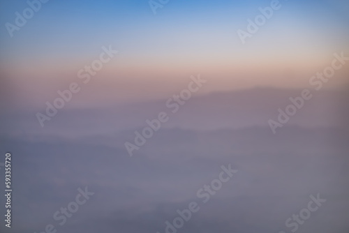 Abstract view of blurry hills and mountain ranges at sunset, warm sunset hues in the mountains in the evening