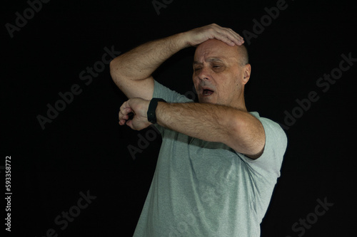 old man worried late on black background