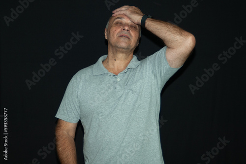 mature man, tired, worried, bored, isolated black background