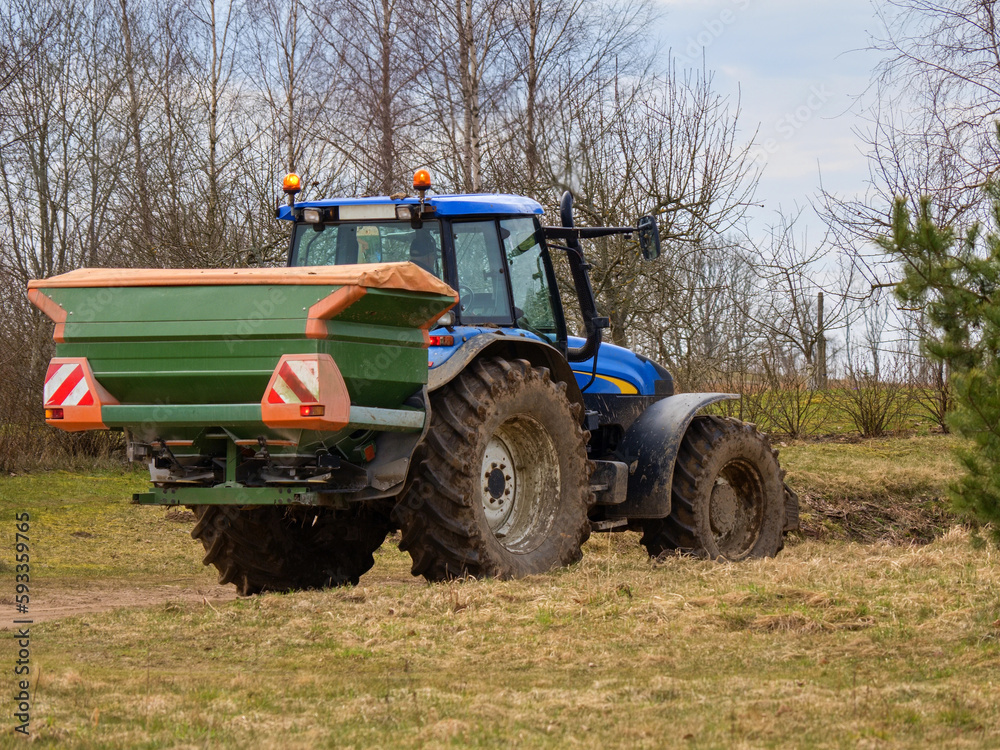 Spring, the beginning of sowing. A seeder attached to a tractor. Spring, the beginning of sowing. A seeder attached to a tractor.