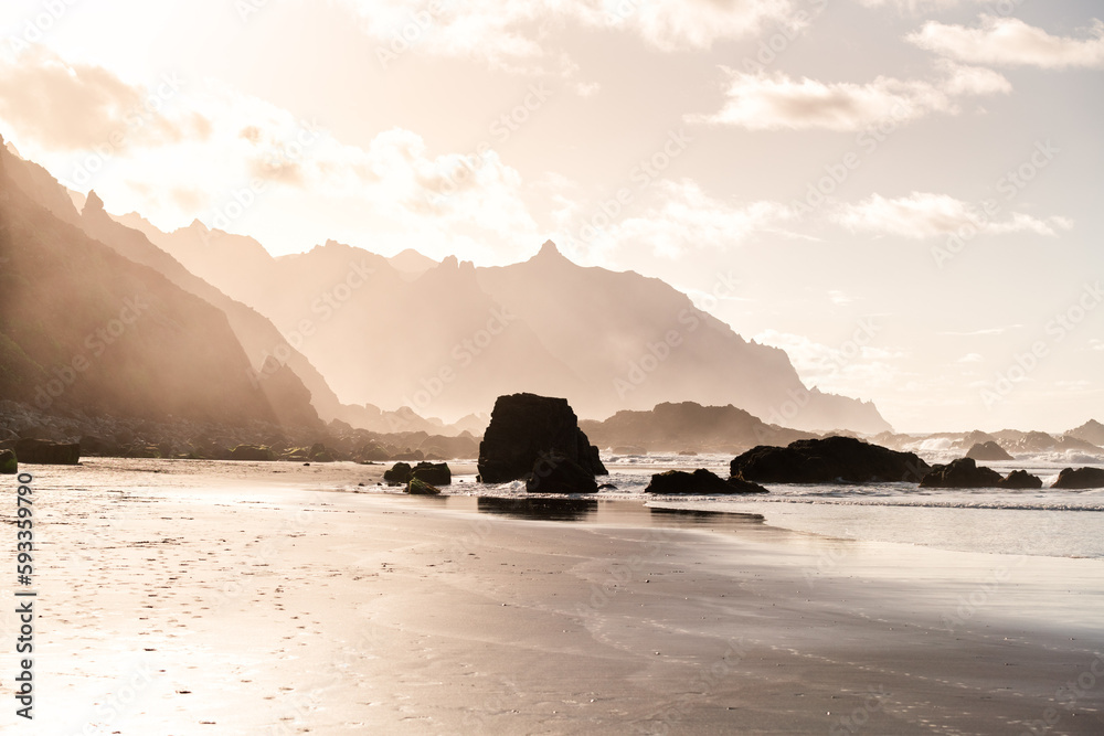 Stunning sunset on a black sand beach with mountains in the background. Benijo Beach, Tenerife