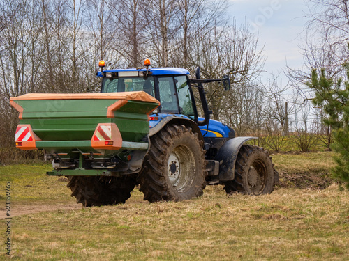 Spring  the beginning of sowing. A seeder attached to a tractor.