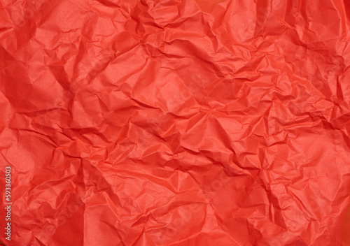 Crumpled red paper sheet, paper texture. Background for designers
