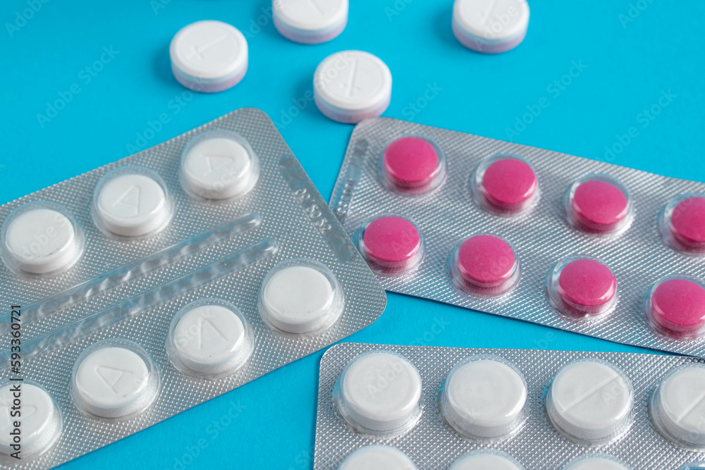 many medicinal tablets on a blue background many medicinal tablets on a blue background