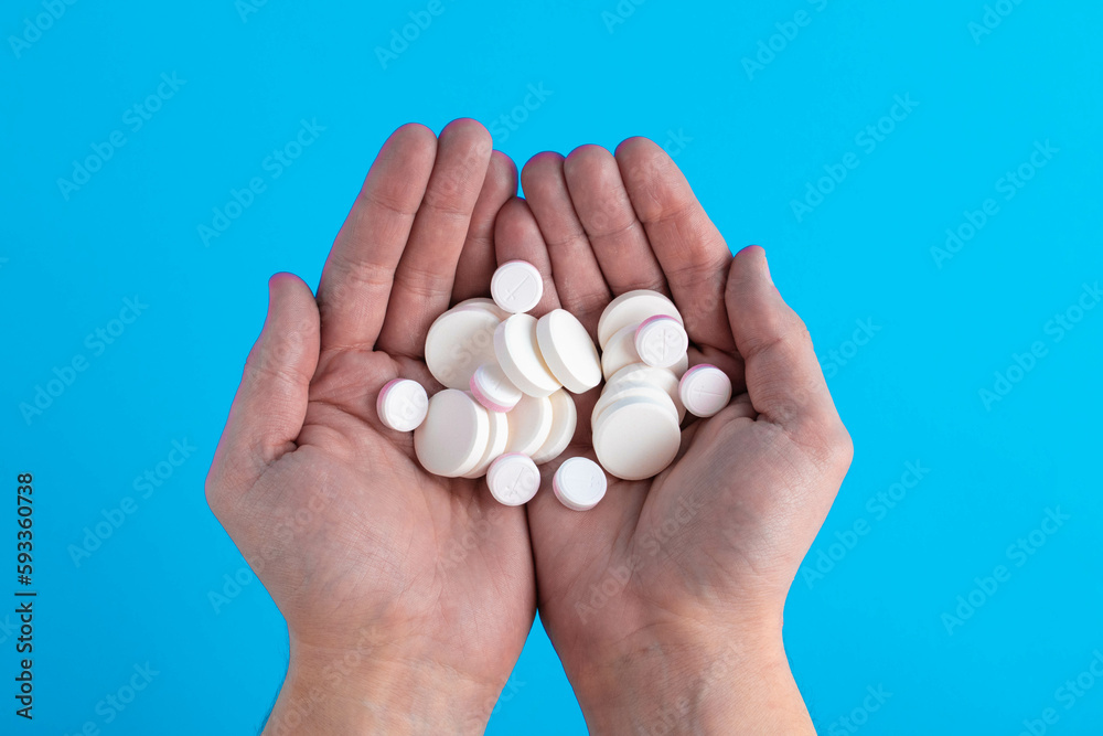 Pills and medicines in hand against a blue background. Pills and medicines in hand against a blue background.