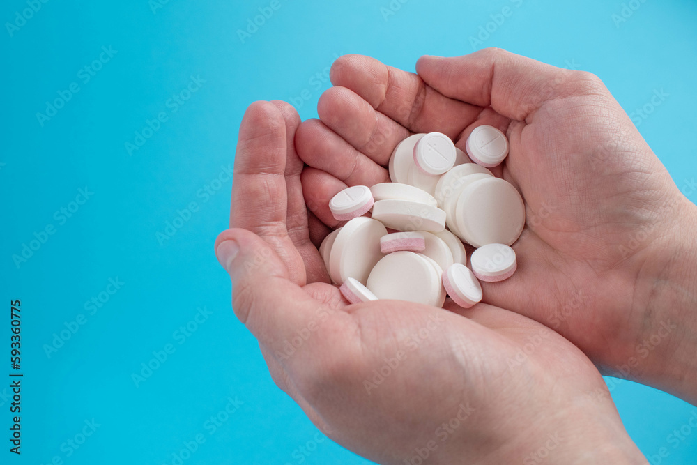 Pills and medicines in hand against a blue background. Pills and medicines in hand against a blue background.