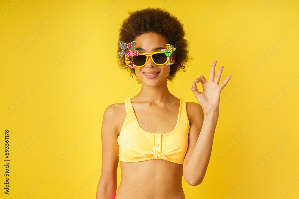 Happy woman in vacation with ok gesture
