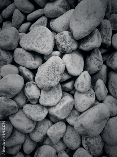 Decorative pebbles for the garden in shades of gray and black. Stone background.
