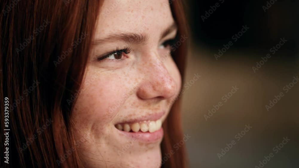 Portrait of charming young red haired ginger woman with freckles looking around on the street in the city centre alone Close up of pretty girl smiling outdoors Portrait of charming young red haired ginger woman with freckles looking around on the street in the city centre alone Close up of pretty girl smiling outdoors