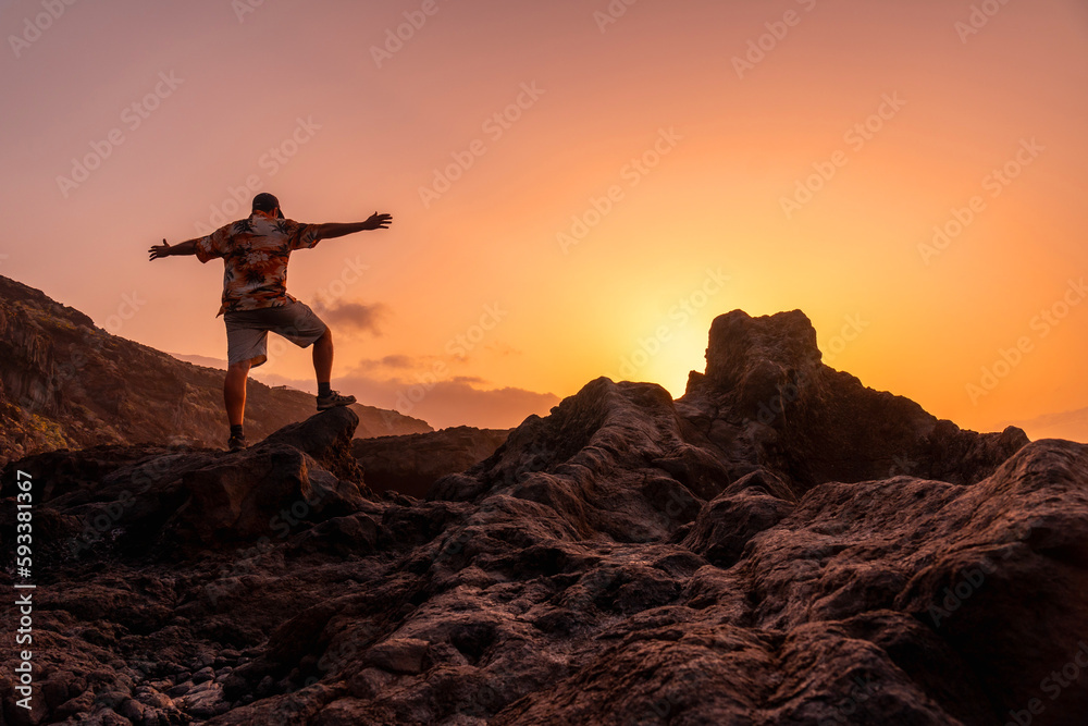 El Hierro Island. Canary Islands, a man enjoying holidays in Charco Azul at sunset, freedom by the sea