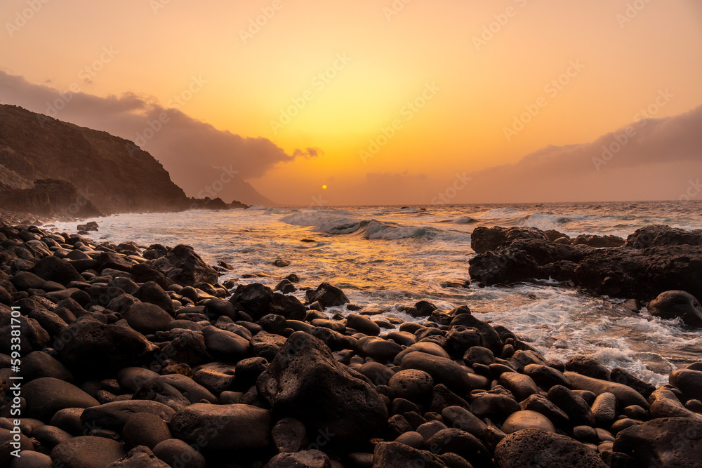 El Hierro Island. Canary Islands, landscape of stones next to Charco azul in spring orange sunset El Hierro Island. Canary Islands, landscape of stones next to Charco azul in spring orange sunset