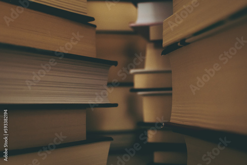 Walls of books. A background with piles of several fictional books