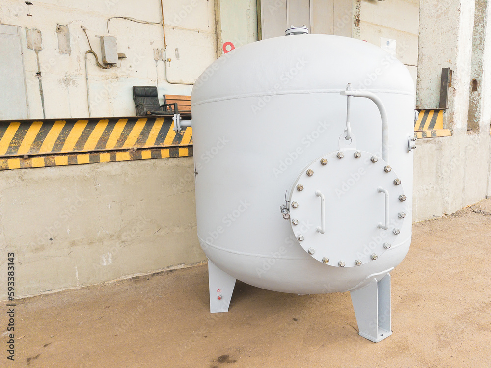 Air receiver for various media close up, used as a storage tank for compressed gas or liquid under pressure, and as a buffer capacity for smoothing out pressure fluctuations in gas on industrial plant Air receiver for various media close up, used as a storage tank for compressed gas or liquid under pressure, and as a buffer capacity for smoothing out pressure fluctuations in gas on industrial plant