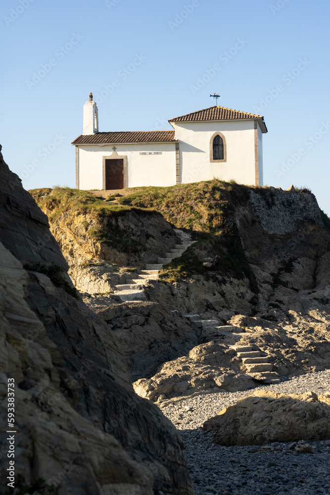 Fototapeta premium Virxe do Porto (Valdoviño) hermitage and cliffs in the Rias Altas touristic area of Galicia at sunset, Meiras, Spain.