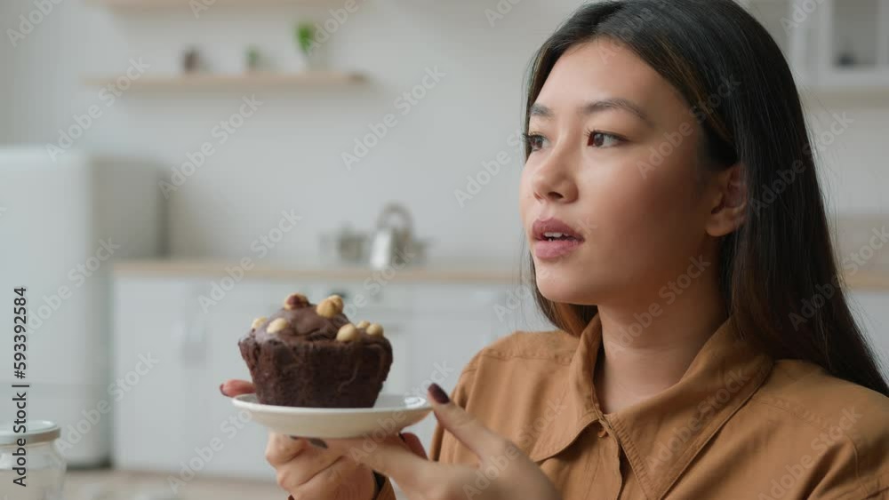 Refusing Dessert Asian korean woman hungry girl in kitchen hold high-calorie cake deny ...