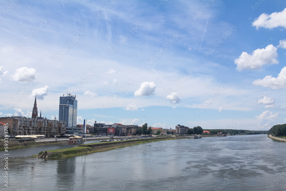 OSIJEK, CROATIA - JUNE 6, 2016: Panorama and skyline of Osijek from Drava river with skyscrapers & the Cathedral of the city. Osijek is a major city of the region of Slavonia in Northern Croatia OSIJEK, CROATIA - JUNE 6, 2016: Panorama and skyline of Osijek from Drava river with skyscrapers & the Cathedral of the city. Osijek is a major city of the region of Slavonia in Northern Croatia