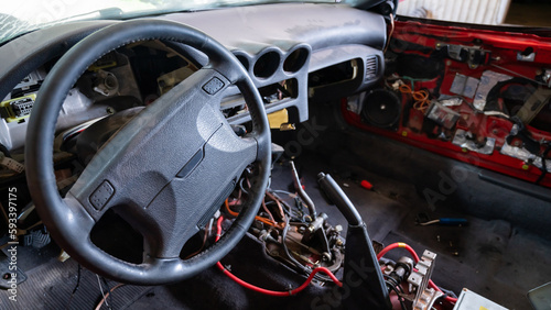 Car interior with disassembled electrics in the garage.