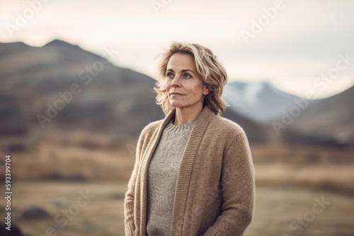 Portrait of a beautiful middle-aged woman with blond hair in the mountains © Robert MEYNER