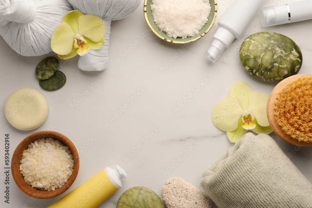 Frame made of different cosmetic products on white marble table, flat lay and space for text. Spa composition Frame made of different cosmetic products on white marble table, flat lay and space for text. Spa composition