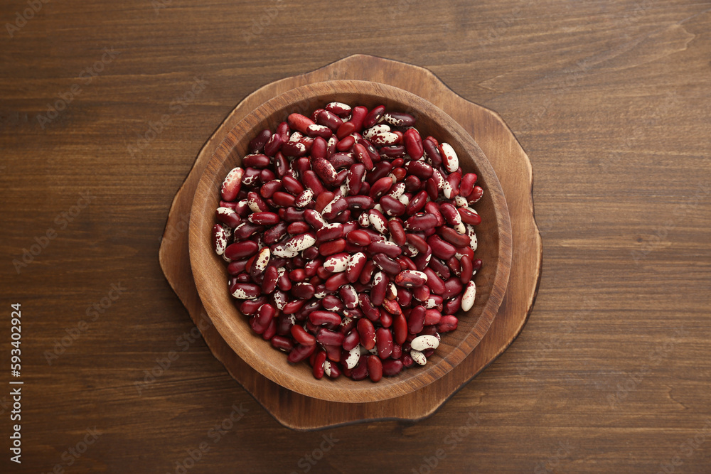 Bowl with dry kidney beans on wooden table, top view Bowl with dry kidney beans on wooden table, top view