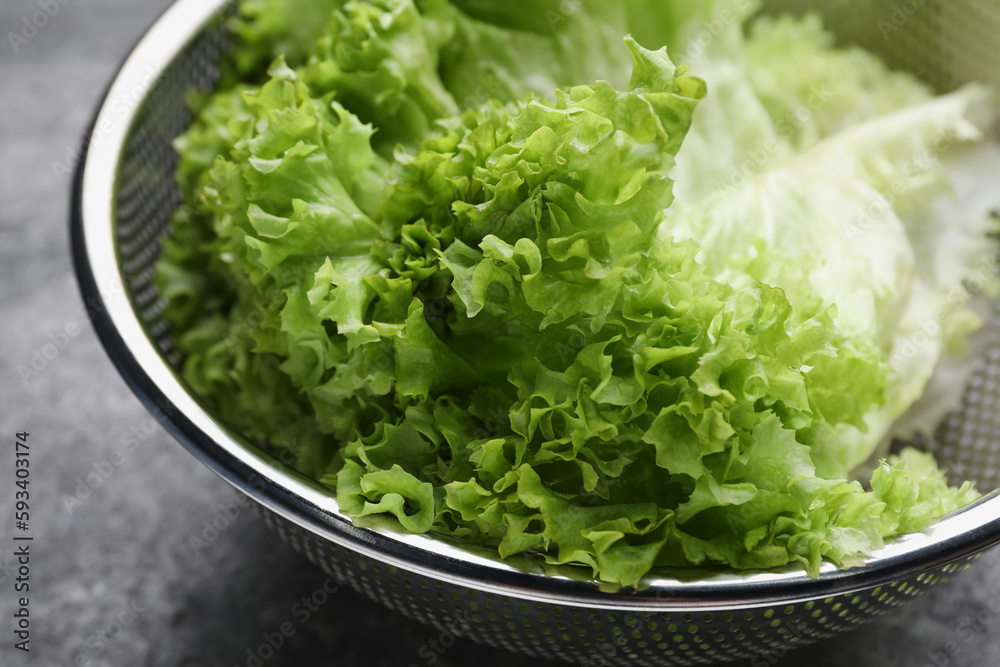 Fresh lettuce on stone table, closeup. Salad greens