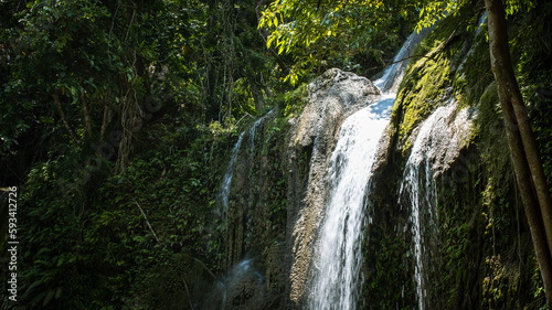 water flow at the waterfall on a sunny day, Pahangog Falls, Bohol, Philippines