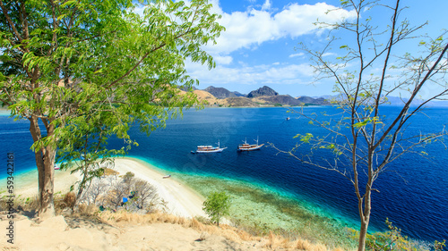 Panorama view of beaches and tourist boat sailing in Kelor Island, Flores Island, Indonesia © Yusnizam Yusof