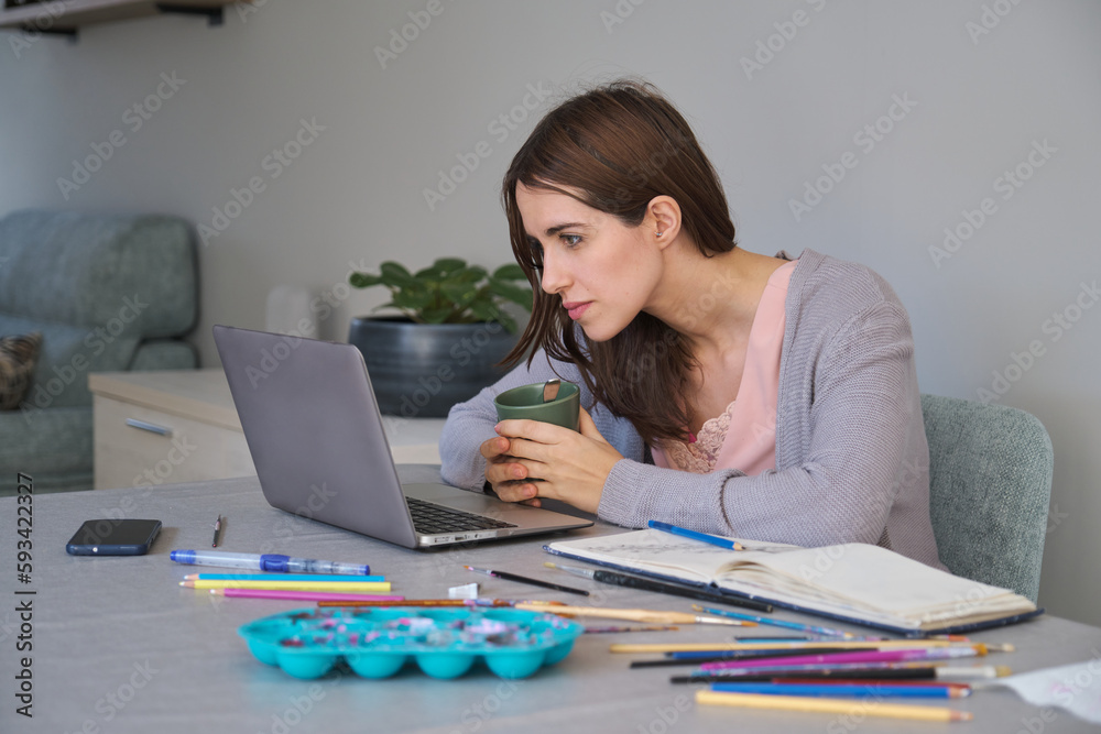 Artist and entrepreneur woman working in a laptop. Unique clothing designer. Artist and entrepreneur woman working in a laptop. Unique clothing designer.