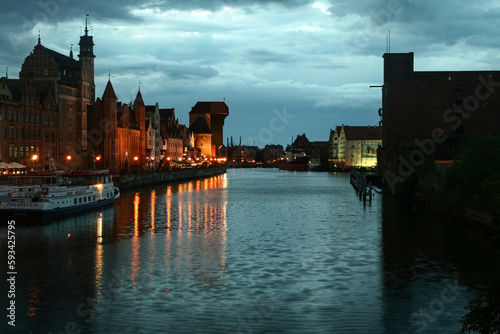 GDANSK, POLAND - JUNE 10, 2009: Waterfront of the Martwwa Wisla Vistula river with Medieval houses of the baltic architecture in the Srodmiescie district of Gdansk at night.