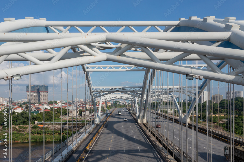 Naklejka premium Dong Tru bridge against blue sky in Hanoi, Vietnam