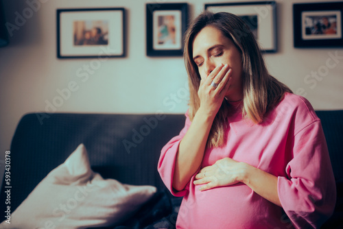 Pregnant Woman in her Third Trimester Feeling Sick at Home. Mother to be suffering from morning sickness late into her pregnancy
 photo