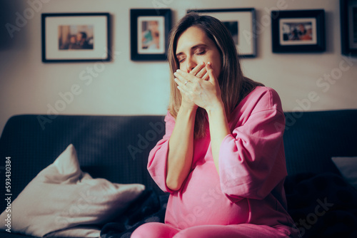 Pregnant Woman in her Third Trimester Feeling Sick at Home. Mother to be suffering from morning sickness late into her pregnancy
 photo