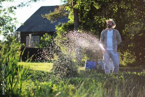 Man farmer watering a vegetable garden © alexkich