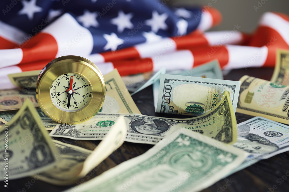 Money bill with golden Compass. Bullets and cartridge cases as a military concept. Close up US Currency and compass. business, financial idea, concept, symbol of crisis, inflation Money bill with golden Compass. Bullets and cartridge cases as a military concept. Close up US Currency and compass. business, financial idea, concept, symbol of crisis, inflation