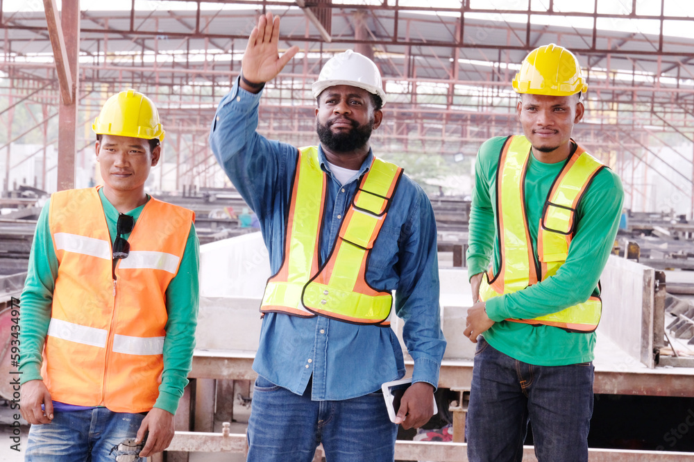 Smiling engineers and construction workers at the job site. Smiling engineers and construction workers at the job site.