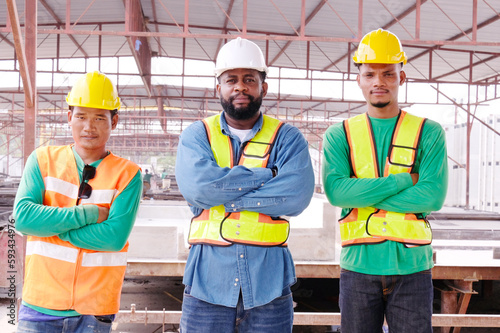 Smiling engineers and construction workers at the job site.