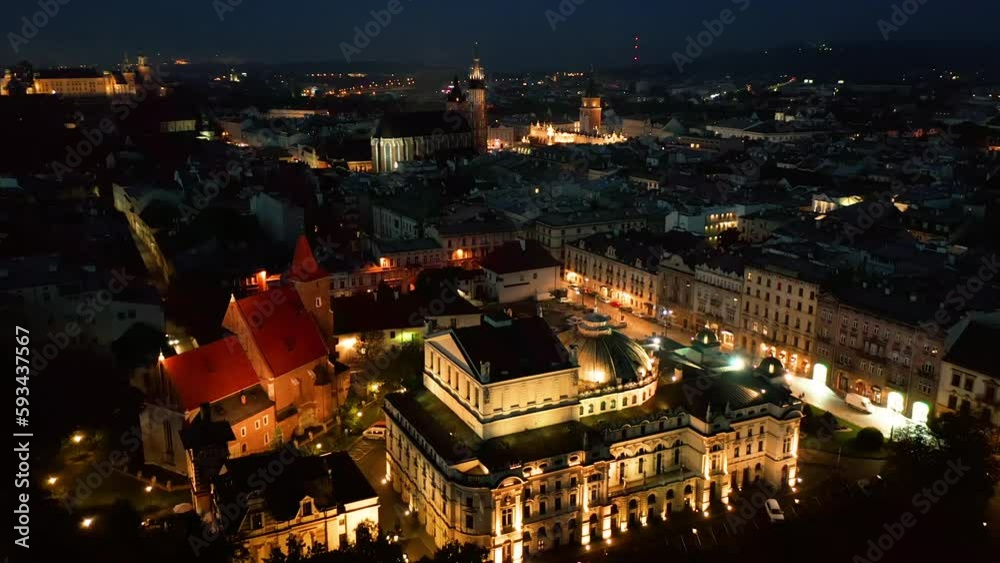 Panorama of illuminated Old Town (Main Square, Saint Mary's Basilica, Sukiennice - Town Hall, Town Hall Tower, Main Theater) in Krakow, Poland at night. Panorama of illuminated Old Town (Main Square, Saint Mary's Basilica, Sukiennice - Town Hall, Town Hall Tower, Main Theater) in Krakow, Poland at night.