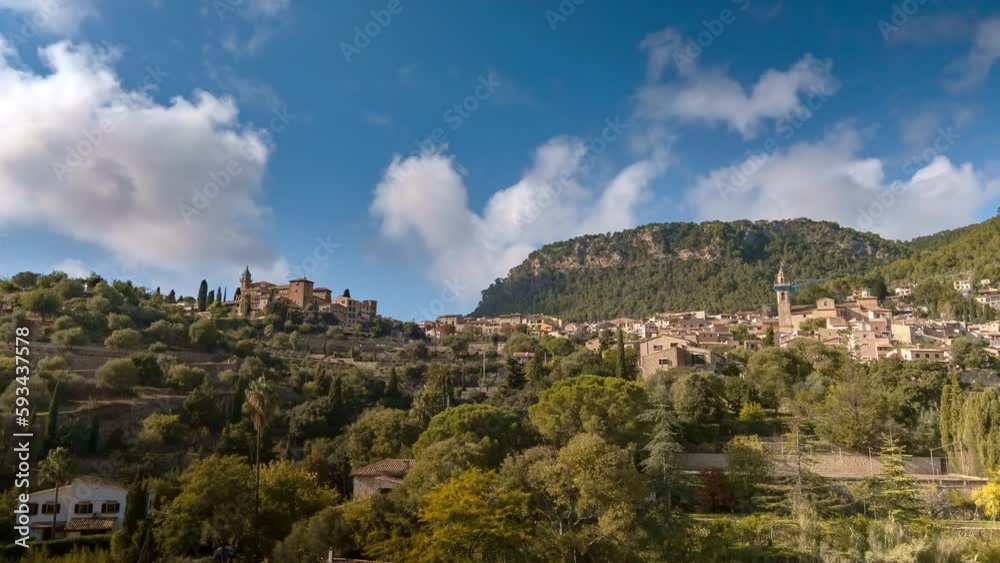 Experience the beauty of Valdemossa in Mallorca in a stunning timelapse video from Shutterstock. Blue skies and clouds pass by while majestic mountains and colorful houses are on display.2 ProRes422HQ Experience the beauty of Valdemossa in Mallorca in a stunning timelapse video from Shutterstock. Blue skies and clouds pass by while majestic mountains and colorful houses are on display.2 ProRes422HQ