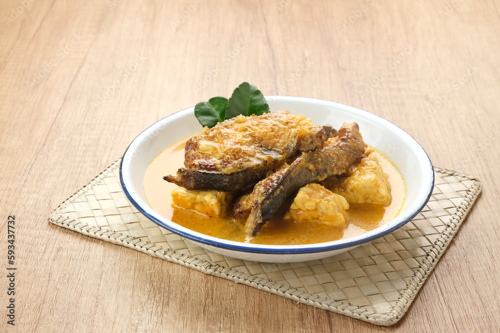 Mangut, made from smoked stingray fish cooked with spices and coconut milk. Indonesian traditional food.
Mangut, made from smoked stingray fish cooked with spices and coconut milk. Indonesian traditional food.