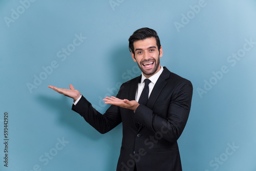 Confident businessman in formal suit making holding hand gesture to indicate promotion or advertising on empty space with excited facial expression and gesture on isolated background. Fervent