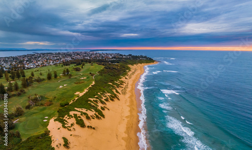 Aerial sunrise at the seaside and golf course with views