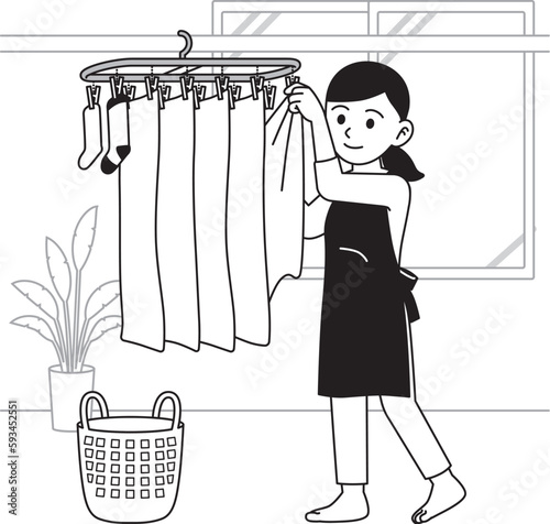 洗濯物を部屋干しする主婦　モノクロ
