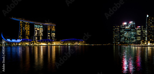 Singapore skyline illuminated at night on waterfront