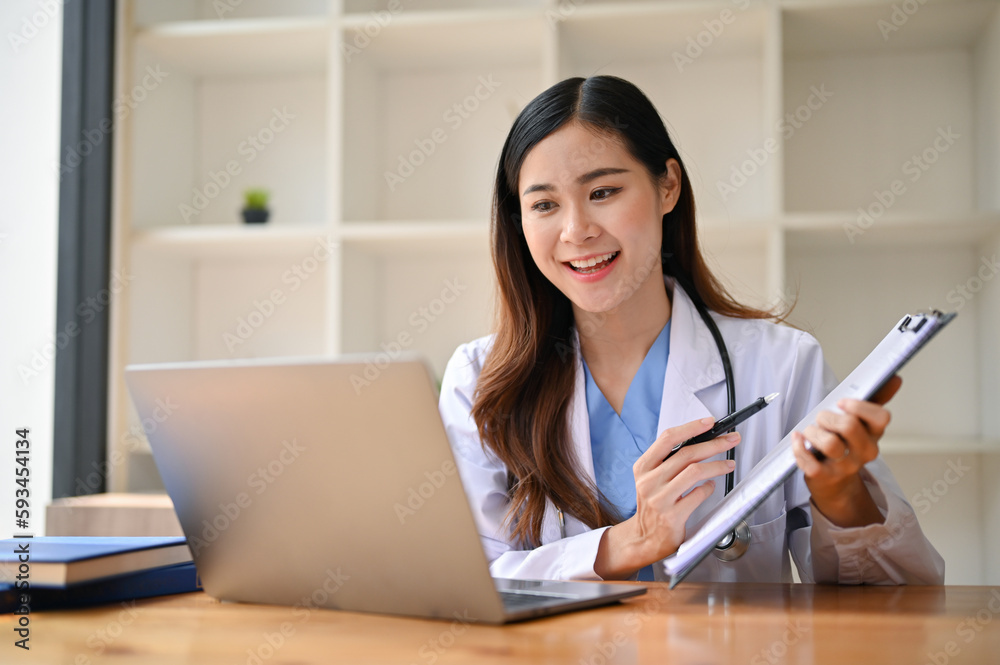 An Asian female doctor having an online medical webinar with her team An Asian female doctor having an online medical webinar with her team