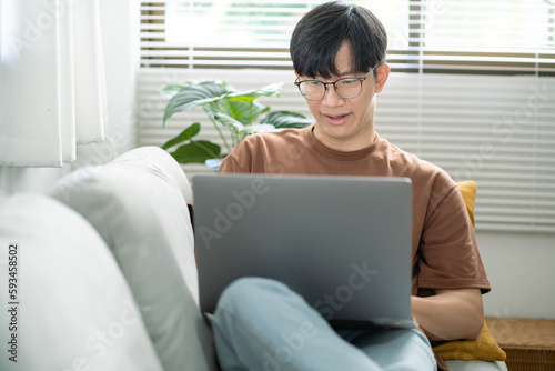 Man work from home. work online on laptop. Asian businessman working online business concept with social distancing laptop online meeting. © Charlie's
