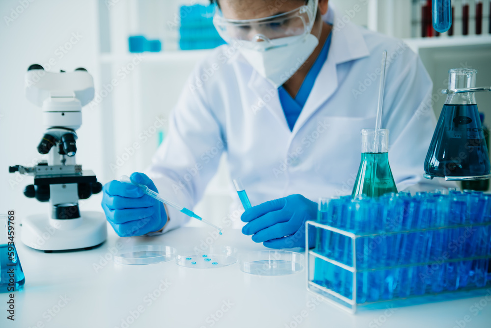 Fototapeta premium Male scientist researcher conducting an experiment working in chemical laboratory