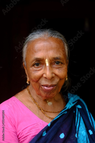 Portrait of a south asian elderly grandmother wearing traditional colourful clothes named saree