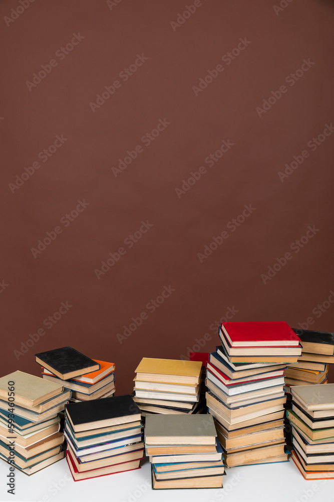 education science learning library stack of books on brown background education science learning library stack of books on brown background