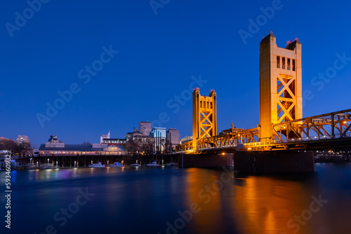 A view of Tower Bridge in Sacramento, CA from River Walk Park at dusk