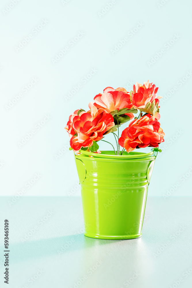 Creative spring concept made with  garden flowers in green pot.